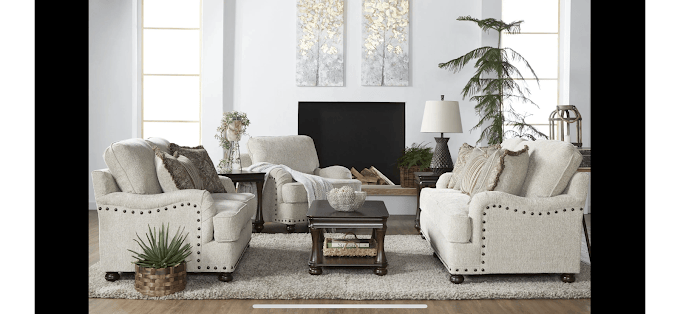 Cozy living room with neutral sofas, coffee table, and decorative plants